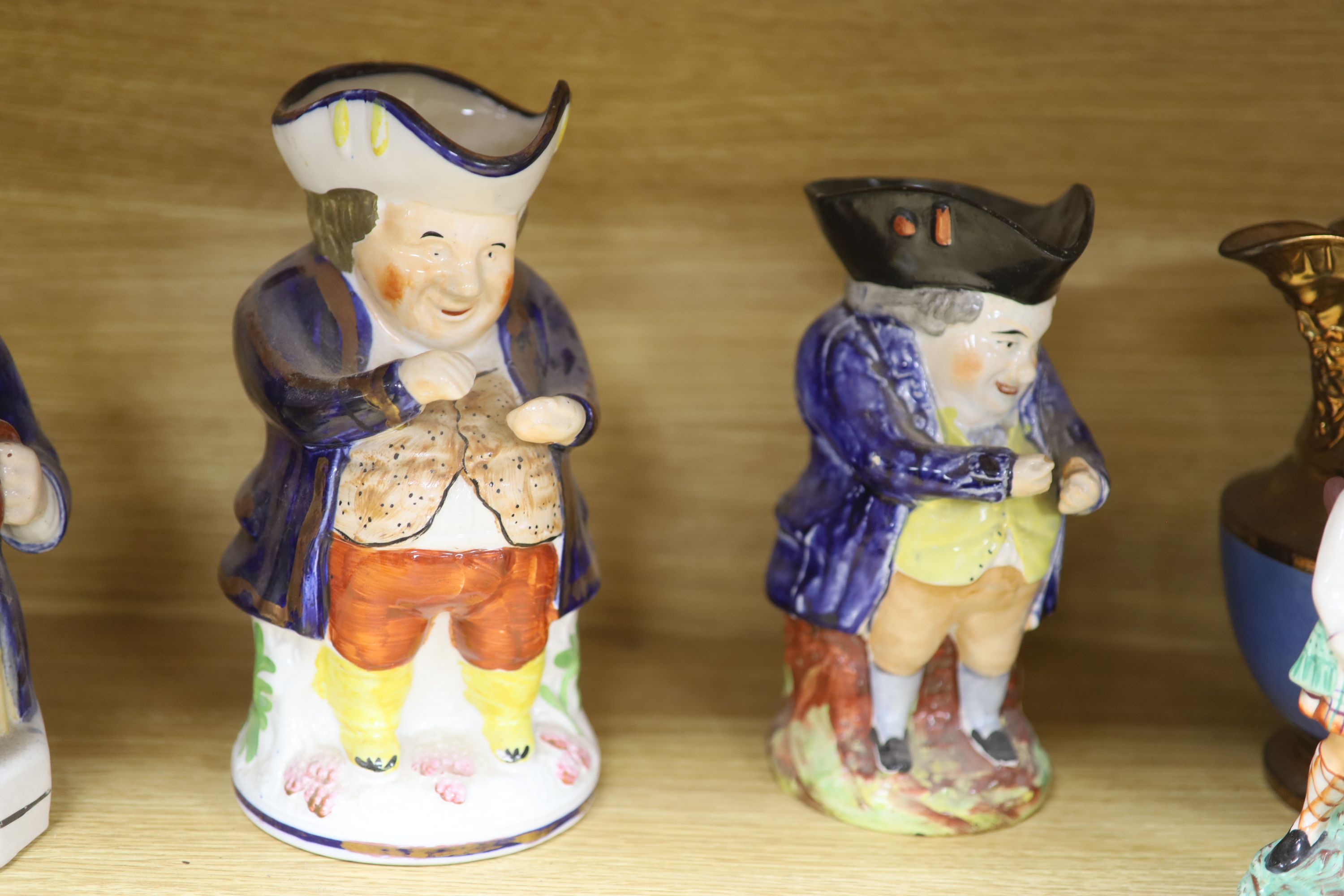 A quantity of Staffordshire pottery, including four Toby jugs, four figures, a copper lustre jug and a silver resist jug (10)